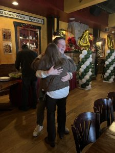2014 graduate Ben hugs Jill Worrall, the program’s former college and career counselor.