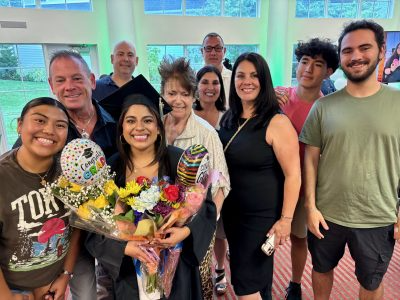 A group of people smile for the camera at a graduation celebration.