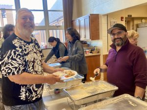 NewBridge client John Donegan in the buffet line. He really liked the stuffing!