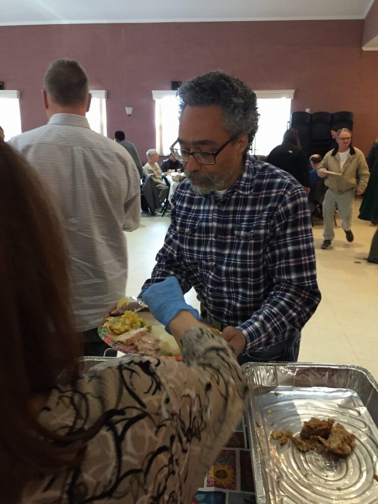 Volunteers serve a Thanksgiving dinner. 
